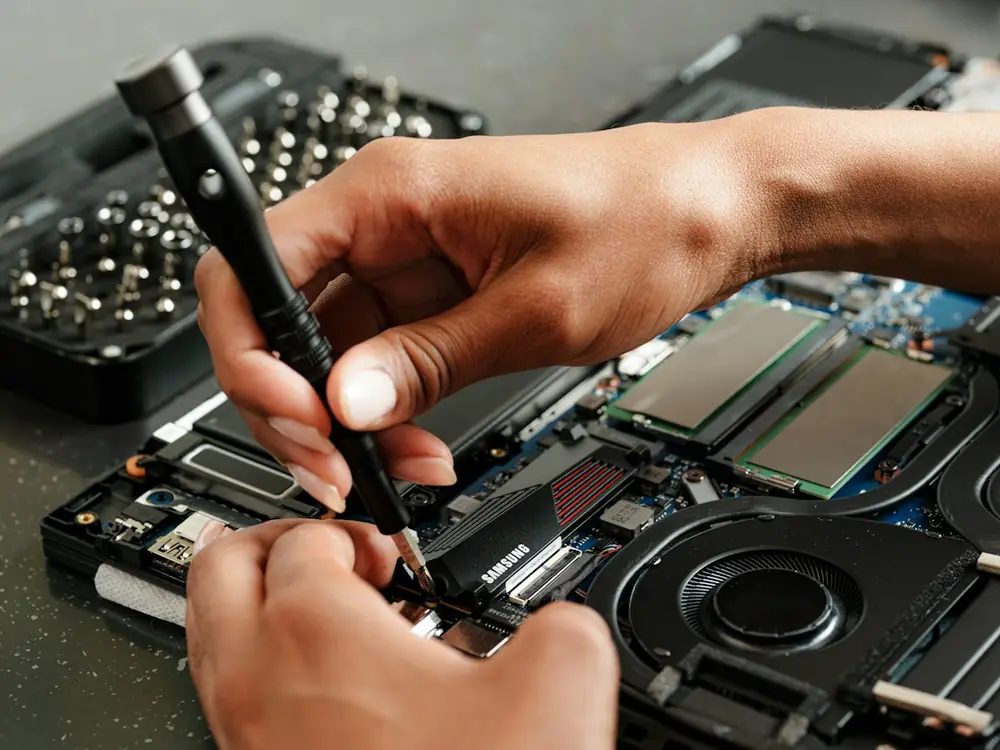 Technician repairing a laptop